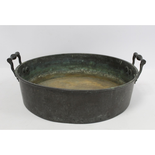 381 - Antique large circular brass skillet with trim turned handles, 38cm diameter. 