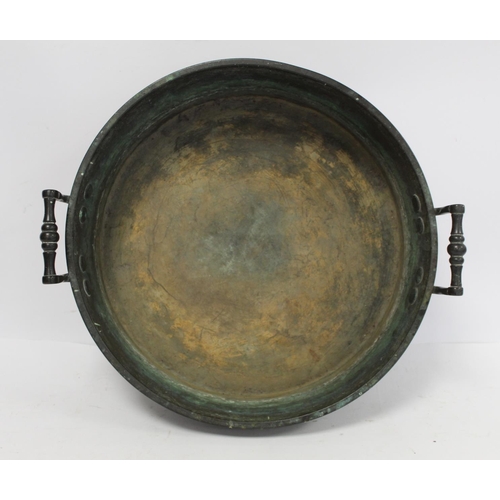 381 - Antique large circular brass skillet with trim turned handles, 38cm diameter. 