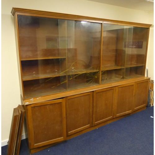 419A - Exceptionally large mid 20th century modernist library bookcase, the bookshelves with four sliding g... 