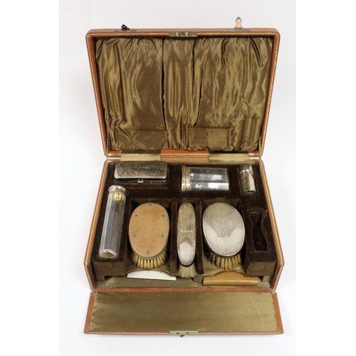 168A - 1920s gentleman's travelling toilette set in fitted leather case, with silver backed brushes, silver... 