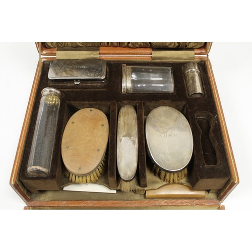 168A - 1920s gentleman's travelling toilette set in fitted leather case, with silver backed brushes, silver... 