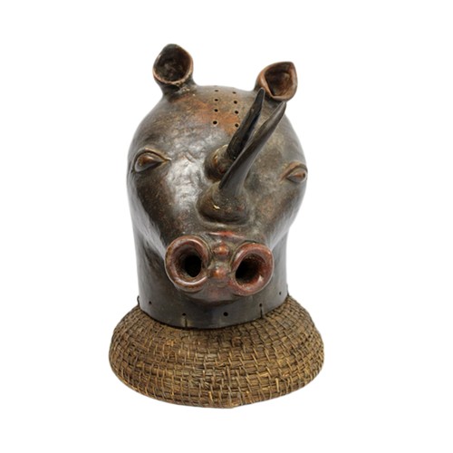 African tribal rhinoceros mask headdress, the polished and patinated composite hollow head surmounted by two horns decorated with shell fragments, on a woven domed base, 42cm high.