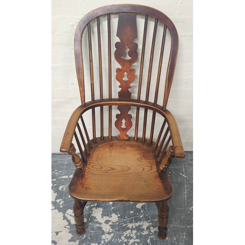 406 - Ash and elm Windsor armchair, the hoop frame with spindle back and pierced splat, raised on turned s... 