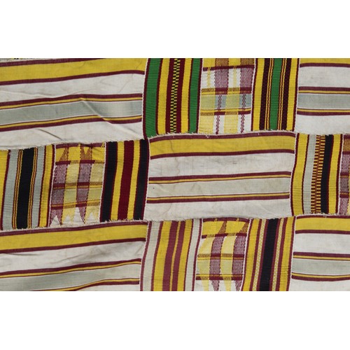 377 - African Asanti Kente cloth in woven silk and cotton striped fabrics in predominantly yellow, cream, ... 