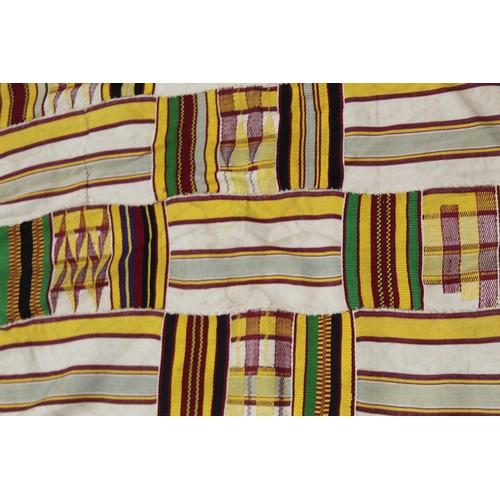 377 - African Asanti Kente cloth in woven silk and cotton striped fabrics in predominantly yellow, cream, ... 