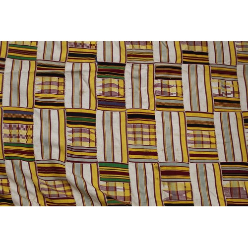 377 - African Asanti Kente cloth in woven silk and cotton striped fabrics in predominantly yellow, cream, ... 