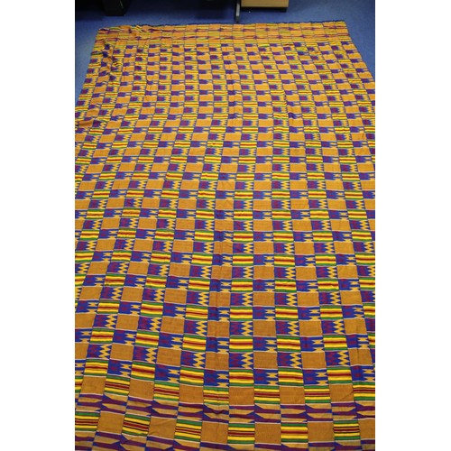 378 - African Asanti Kente cloth in woven silk and cotton fabrics in predominantly blue, yellow, green and... 