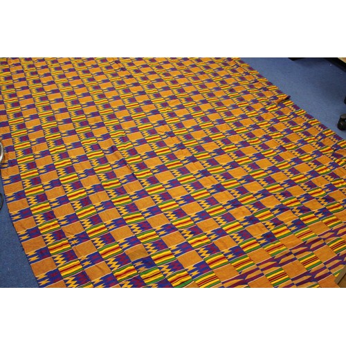 378 - African Asanti Kente cloth in woven silk and cotton fabrics in predominantly blue, yellow, green and... 