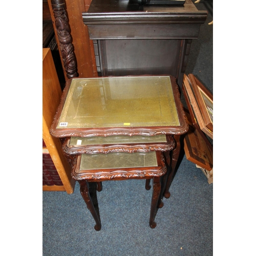 665 - Mahogany nest of three glass top tables.