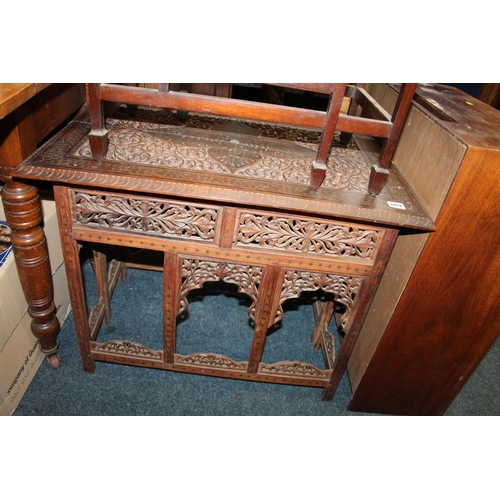 669 - Heavily carved Eastern hardwood table, 76cm wide.