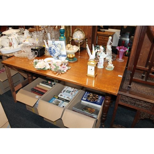 670 - Oak drop leaf table raised on turned supports, 122cm wide.