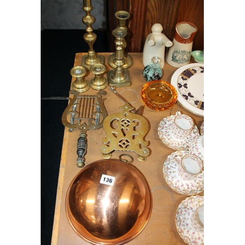 136 - Two brass trivets, brass candlesticks, a copper bowl, etc.