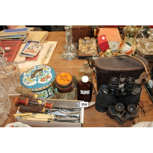 259 - Flatware, a pair of field binoculars, medicine bottles, a vintage tin, etc.