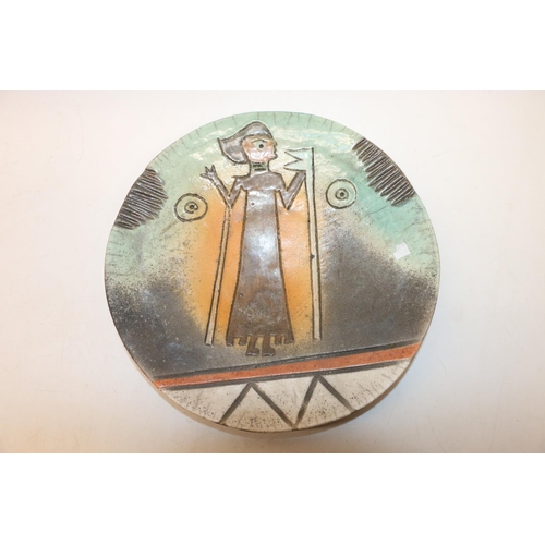 100I - Studio pottery plate decorated with an abstract figure, indistinctly signed to base, 25cm.