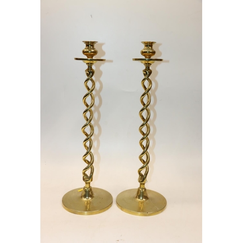 32 - Pair of brass candlesticks with spiral stems. 47cm.