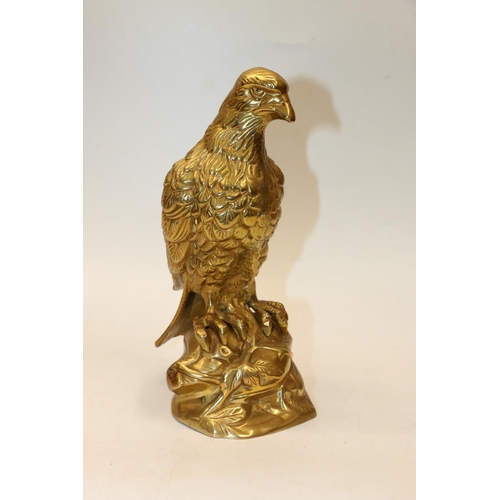 37 - Cast brass model of a bird of prey. 26cm.