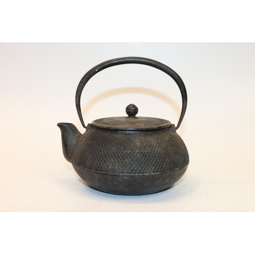 40 - Oriental cast metal teapot, signed to underside. 10cm.