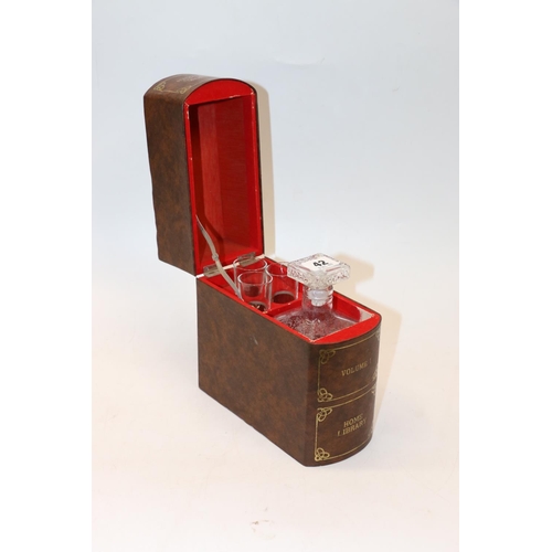 42 - Hinge top box in the form of a book containing a decanter and three glasses. 21cm.