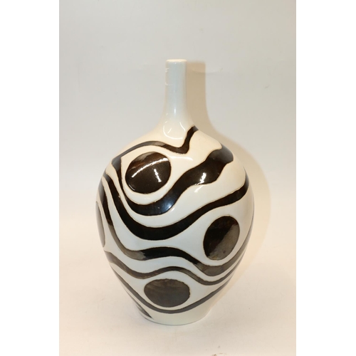 66 - Studio pottery vase decorated with brown waves and spots on a cream ground, 37cm.