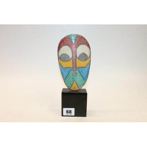 68 - Colourful ceramic face mask mounted on plinth base, 22.5cm.