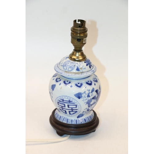 72 - Oriental blue and white lamp base on turned wooden stand, 23cm.