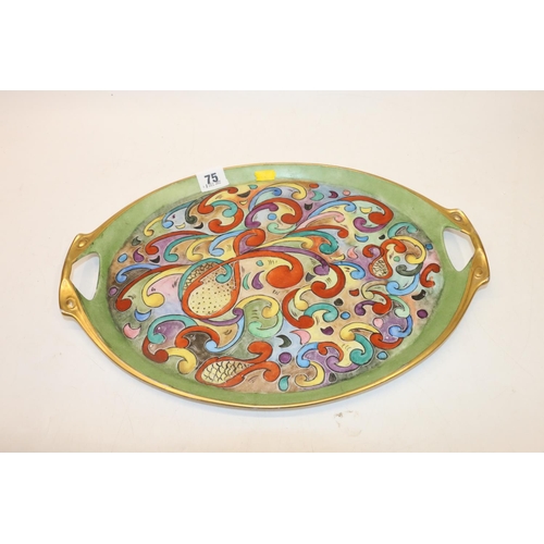 75 - Twin handled ceramic tray with colourful scrolling decoration, 41cm.