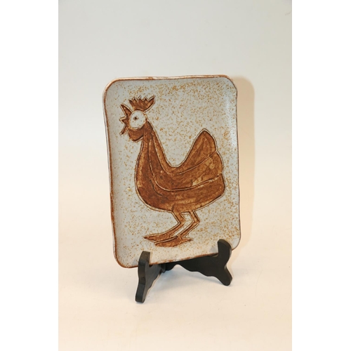 82 - Studio pottery tray decorated with a cockerel, signed ANIKO to reverse, 20cm.