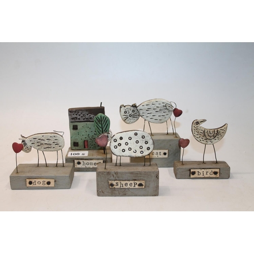 100S - Five Studio Pottery decorative models. Home, Cat, Sheep, Dog & Bird on wooden stands.