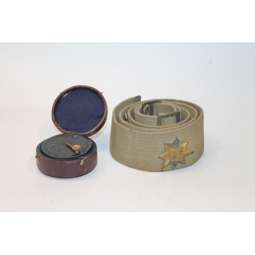 47 - Cased pocket navigation device and a military belt.