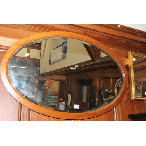 700 - Oak framed bevel edged oval wall mirror.