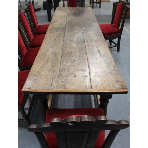 404 - 17th century style oak refectory table, with fixed plank top, above a carved frieze, raised on turne... 