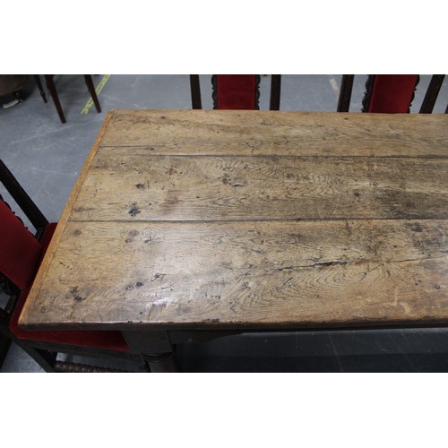 404 - 17th century style oak refectory table, with fixed plank top, above a carved frieze, raised on turne... 