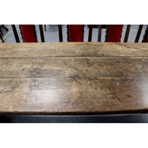 404 - 17th century style oak refectory table, with fixed plank top, above a carved frieze, raised on turne... 