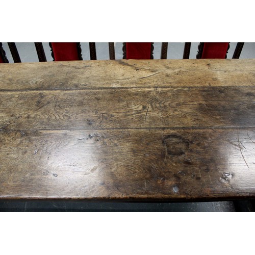 404 - 17th century style oak refectory table, with fixed plank top, above a carved frieze, raised on turne... 