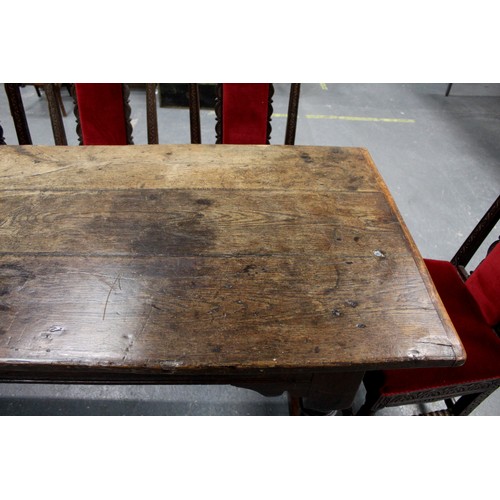 404 - 17th century style oak refectory table, with fixed plank top, above a carved frieze, raised on turne... 