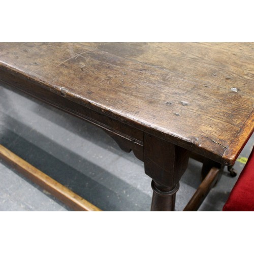 404 - 17th century style oak refectory table, with fixed plank top, above a carved frieze, raised on turne... 