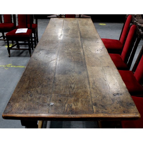 404 - 17th century style oak refectory table, with fixed plank top, above a carved frieze, raised on turne... 