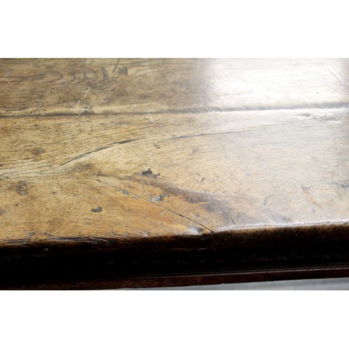 404 - 17th century style oak refectory table, with fixed plank top, above a carved frieze, raised on turne... 