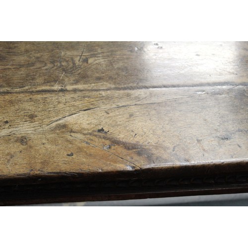 404 - 17th century style oak refectory table, with fixed plank top, above a carved frieze, raised on turne... 