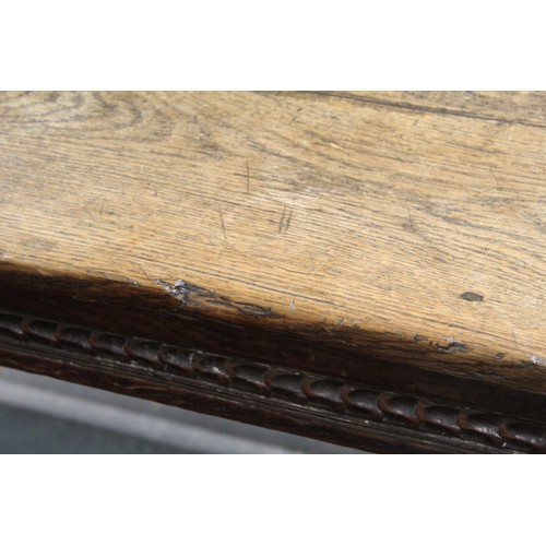 404 - 17th century style oak refectory table, with fixed plank top, above a carved frieze, raised on turne... 