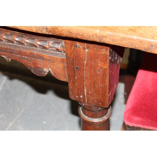 404 - 17th century style oak refectory table, with fixed plank top, above a carved frieze, raised on turne... 