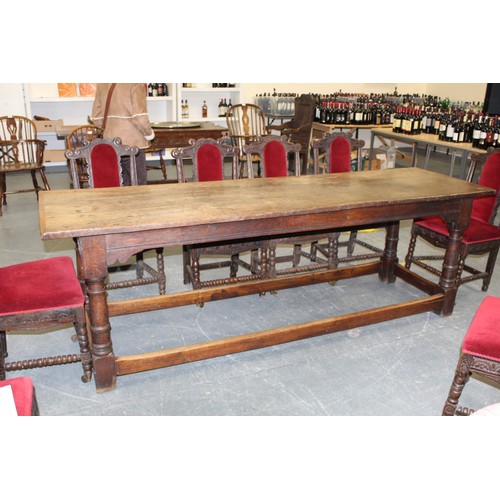 404 - 17th century style oak refectory table, with fixed plank top, above a carved frieze, raised on turne... 