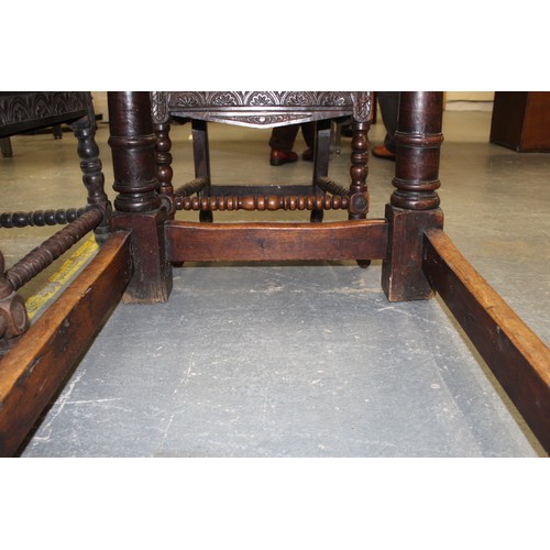 404 - 17th century style oak refectory table, with fixed plank top, above a carved frieze, raised on turne... 