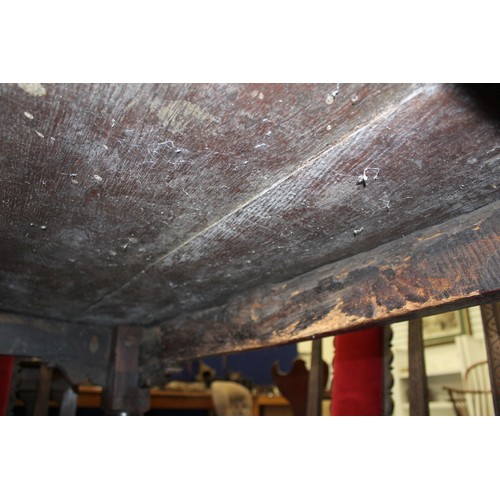 404 - 17th century style oak refectory table, with fixed plank top, above a carved frieze, raised on turne... 