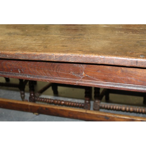 404 - 17th century style oak refectory table, with fixed plank top, above a carved frieze, raised on turne... 