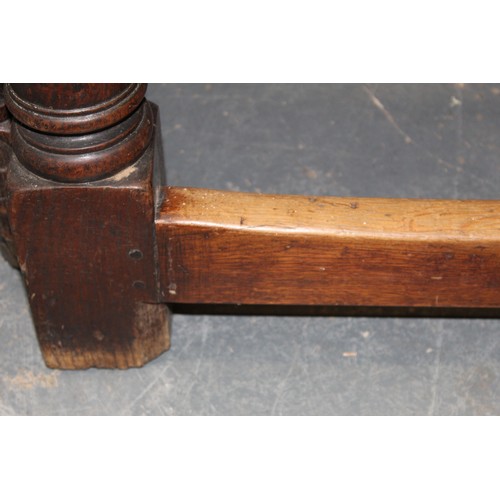 404 - 17th century style oak refectory table, with fixed plank top, above a carved frieze, raised on turne... 