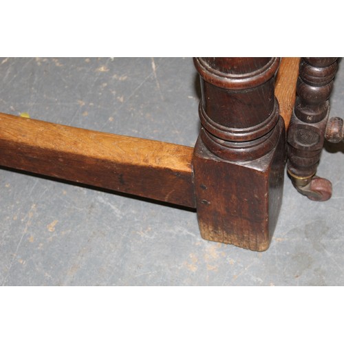 404 - 17th century style oak refectory table, with fixed plank top, above a carved frieze, raised on turne... 