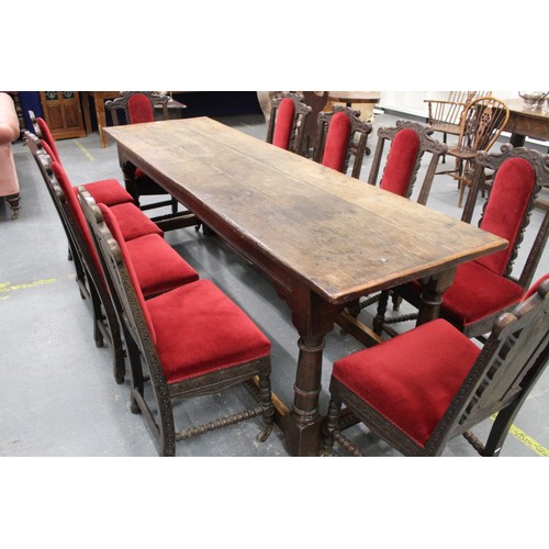 404 - 17th century style oak refectory table, with fixed plank top, above a carved frieze, raised on turne... 