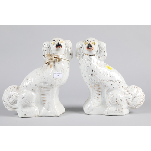 8 - Pair of late 19th century Staffordshire pottery seated dogs; 31cm high