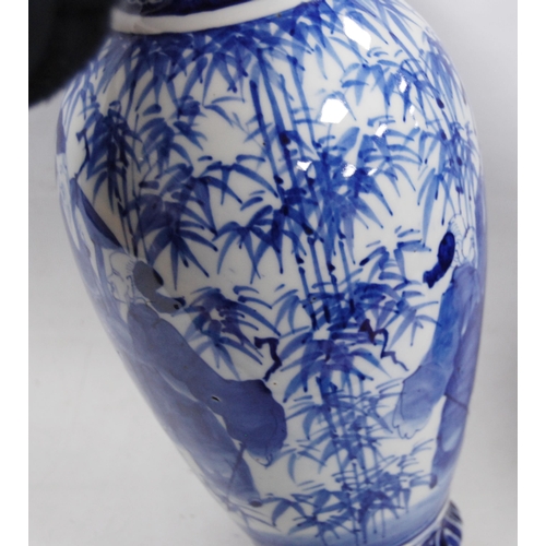 278 - Pair of Delft-style blue and white vases in the Japanese taste, decorated with figures in foliage, u... 